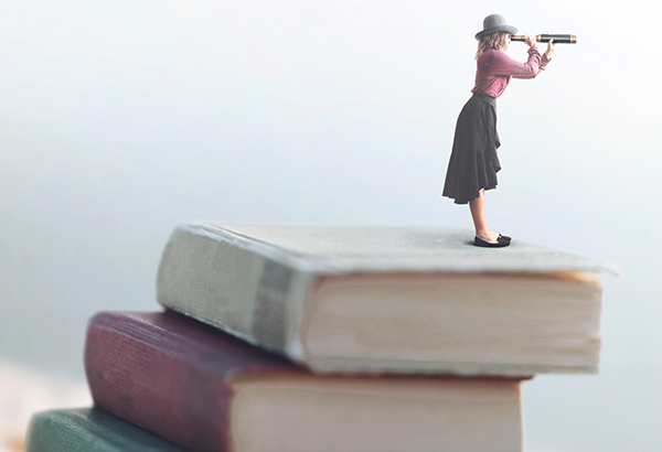 woman with telescope looking on top of books